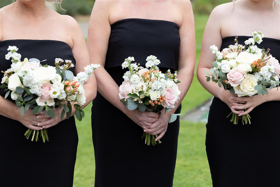 Blush coloured wedding bouquets held by bridesmaids